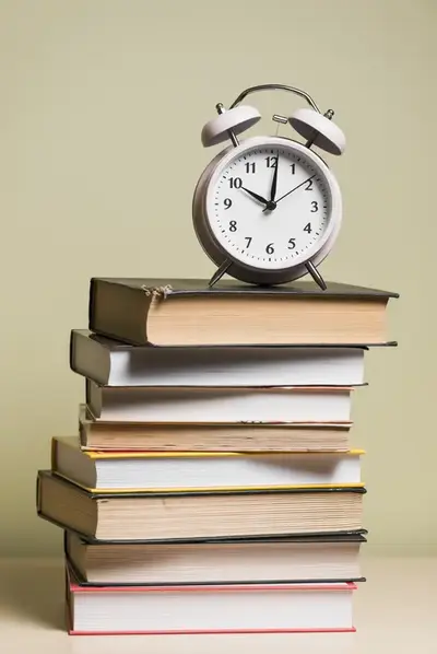 alarm clock top stacked books img